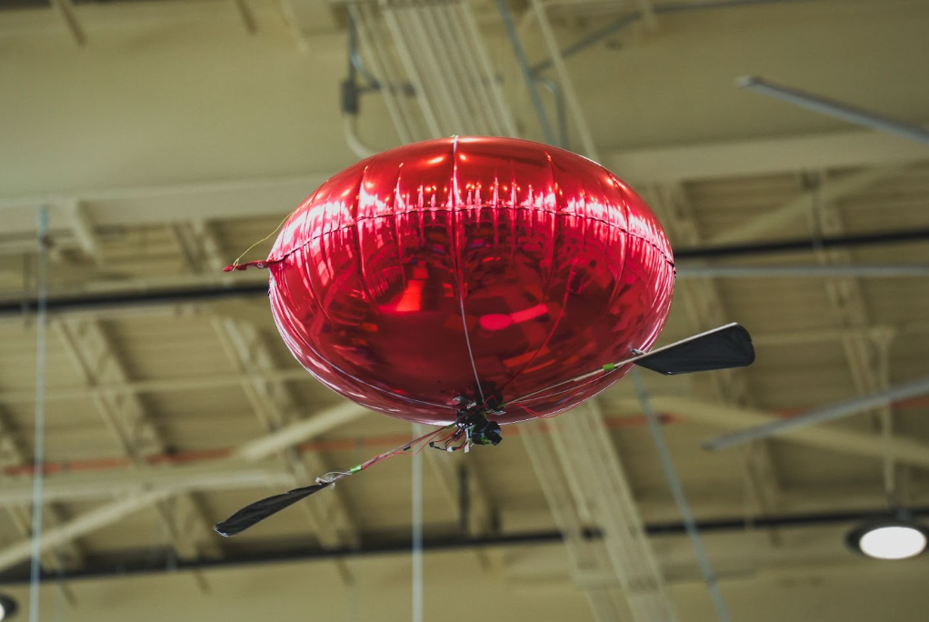 The Spinning Blimp: Design and Control of a Novel Minimalist Aerial Vehicle Leveraging Rotational Dynamics and Locomotion representative figure